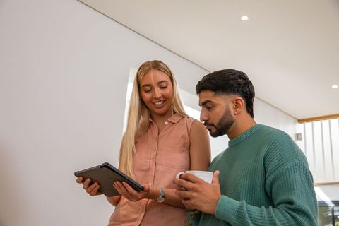 Collaborative Office Meeting with Tablet and Coffee