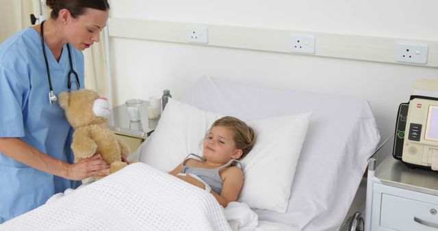 Nurse Comforting Young Child in Hospital Bed with Teddy Bear - Download Free Stock Images Pikwizard.com