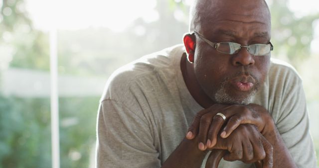 Elderly Man Wearing Glasses Looking Thoughtful Holding Cane - Download Free Stock Images Pikwizard.com