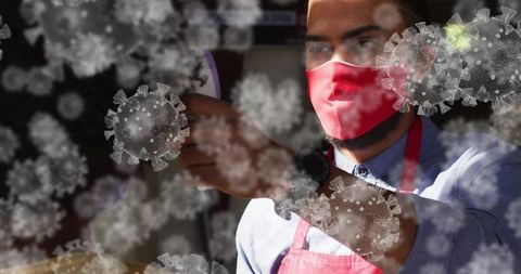 Checking temperature with infrared thermometer during pandemic screening in retail store