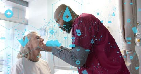 Nurse in burgundy scrubs examining older patient with digital healthcare interface overlay