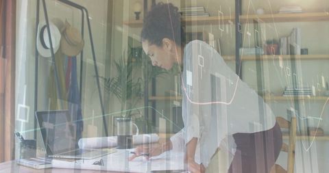 Entrepreneur Analyzing Financial Data in Modern Office