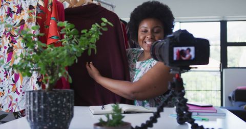 African american vlogger showcasing fashion apparel perseveringly
