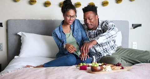 Happy Couple Celebrating Anniversary with Relaxed Indoor Picnic
