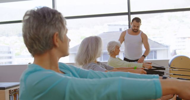 Instructor Leading Senior Pilates Class in Modern Gym - Download Free Stock Images Pikwizard.com