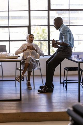 Diverse Professionals Collaborating over Coffee at Office Desk
