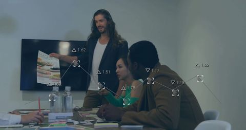 Diverse Team Analyzing Data with Digital Interface in Office Meeting