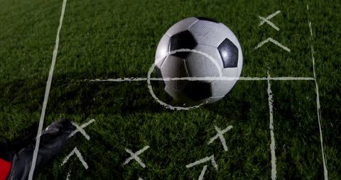 Soccer Strategy Concept with Group Collaborating on Chalkboard Plans