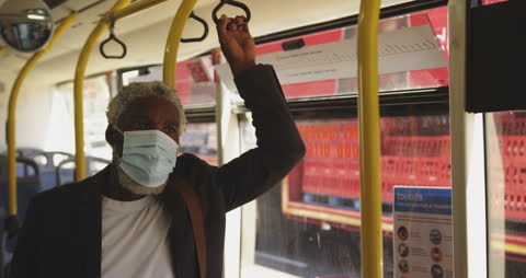 Senior Man in Face Mask Riding Bus During Pandemic