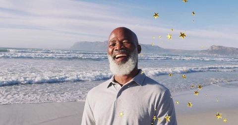 Joyful Senior Man on Beach with Golden Star Overlays