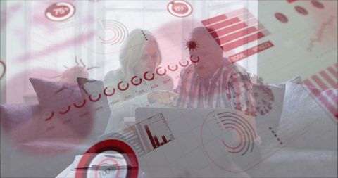 Elderly Couple Analyzing Financial Charts in Living Room
