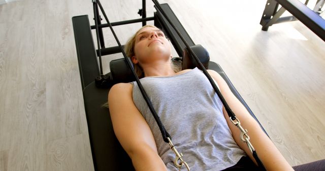 Young Woman Exercising on Pilates Reformer Machine in Fitness Studio - Download Free Stock Images Pikwizard.com