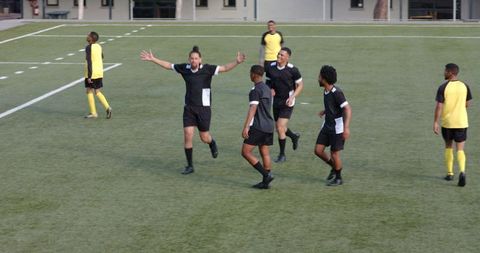 Youth Soccer Team Celebrating Goal During Competitive Match