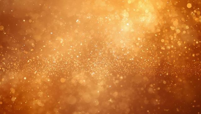 Golden bokeh glitter background with horizontal band of shimmering particles, warm amber glow