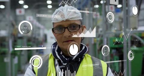 Factory supervisor viewing augmented reality production analytics in hi-vis vest