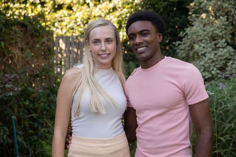 Interracial Couple Enjoying Sunny Day in Vibrant Garden