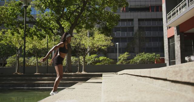 Young Woman Preparing for Parkour Jump in Urban Environment - Download Free Stock Images Pikwizard.com