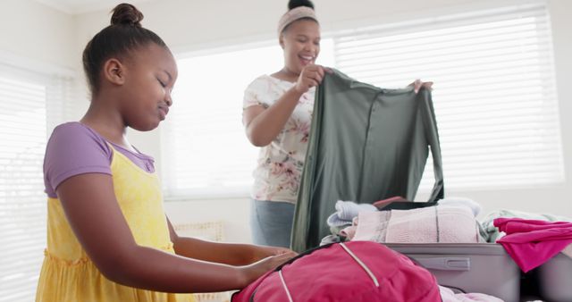 Mother and Daughter Packing for Trip in Bright Room - Download Free Stock Images Pikwizard.com