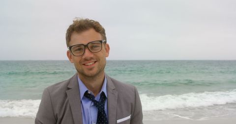 Content Businessman Standing at Seaside Smiling Confidently