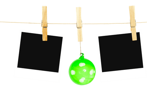 Christmas bauble and blank photos on transparent background