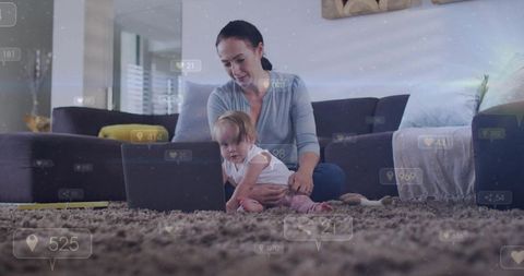 Mother guiding baby on laptop while sitting on living room rug promoting early learning and bonding