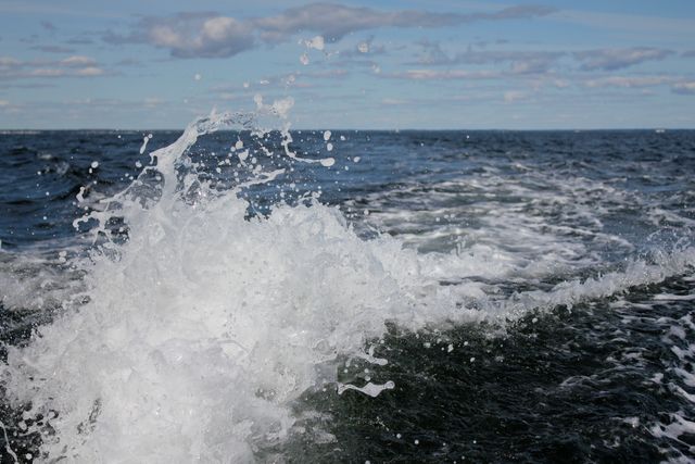 Splashing Water in Open Sea with Blue Sky Background - Download Free Stock Photos Pikwizard.com