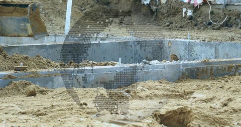 Concrete foundation construction with soil piles and metal stakes