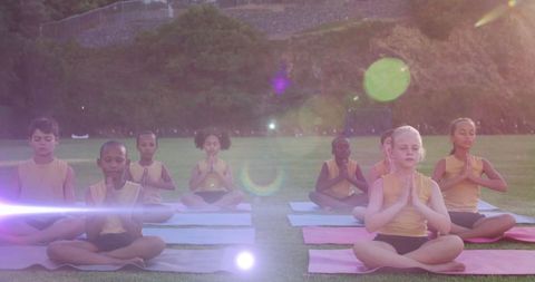 Diverse Children Practicing Yoga in Sunlit Field