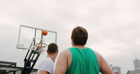 Men Playing Basketball on Outdoor Court Shooting Toward Hoop