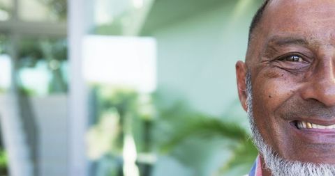 Smiling Biracial Man Outdoors with Grey Hair and Beard