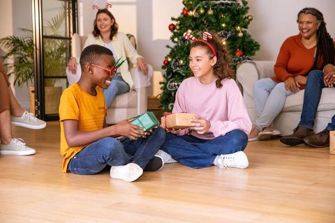 Diverse children exchanging gifts in festive holiday setting