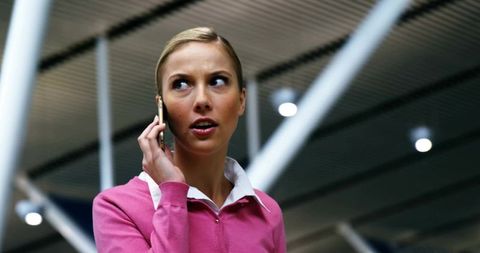Professional woman communicating in modern transit hub