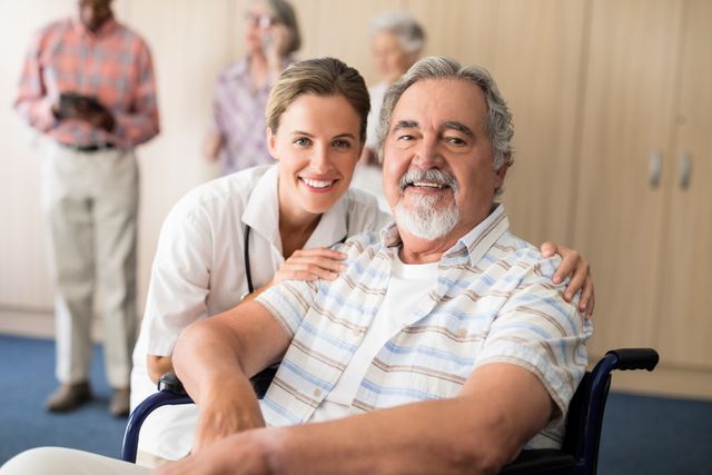 Portrait of smiling female doctor with disabled senior man sitting on wheelchair - Download Free Stock Photos Pikwizard.com