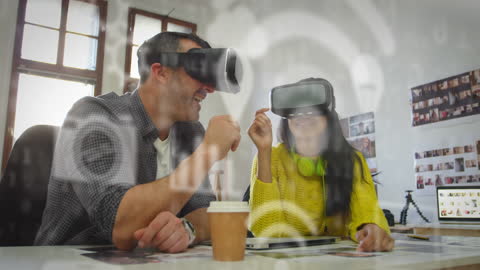 Colleagues Using VR Headsets in Creative Office Environment