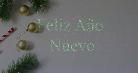 Feliz Año Nuevo with Christmas Ornaments and Pine Branches