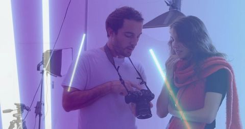 Photographer and model reviewing shots in creative studio