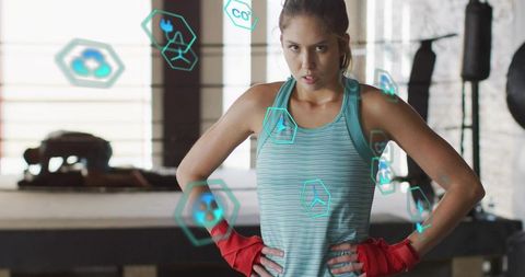 Female Boxer Standing Hands on Hips Showing Focus and Resilience in Boxing Ring
