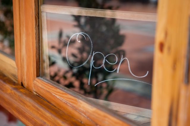 Close up of open text on glass window of coffee shop