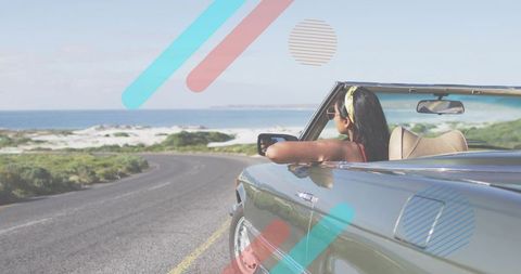Indian woman enjoying coastal roadtrip in convertible with ocean view