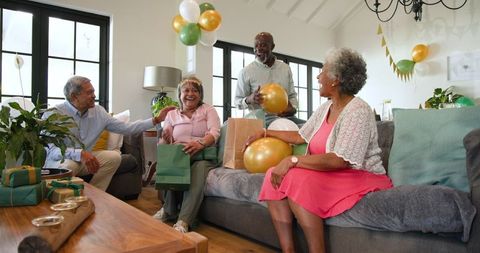 Senior Friends Celebrating Birthday at Cozy Living Room Gathering