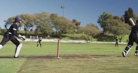 Women Playing Cricket on Sunny Day Enhancing Sports Teamwork