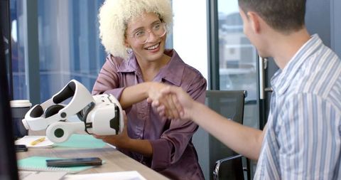 Diverse Professionals Collaborating with Virtual Reality Technology in Modern Office