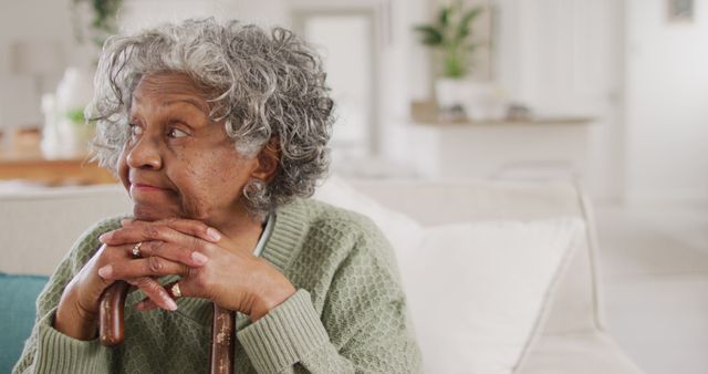 Pensive Senior Woman Resting With Cane in Modern Home - Download Free Stock Images Pikwizard.com