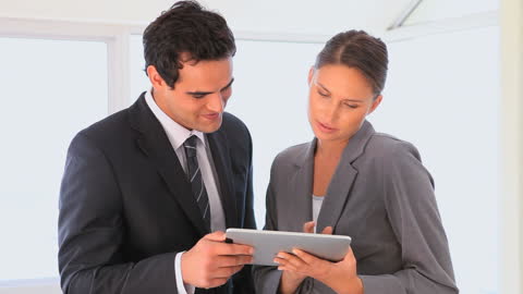 Business Professionals Collaborating on Tablet Technology