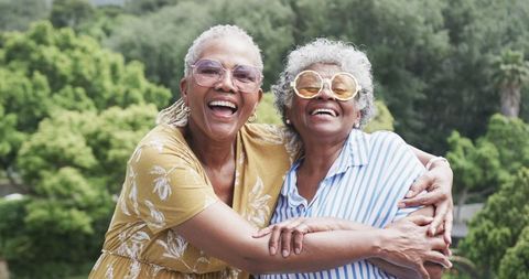 Senior Friends Embracing Outdoors with Joyful Expressions