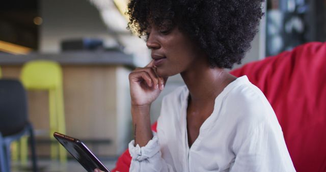 Thoughtful Woman Browsing Smartphone in Modern Interior - Download Free Stock Images Pikwizard.com