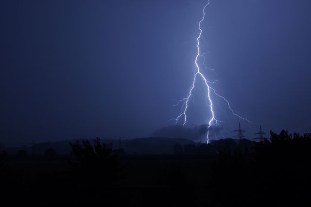 Dramatic Nighttime Lightning Bolt Striking Landscape - Download Free Stock Photos Pikwizard.com