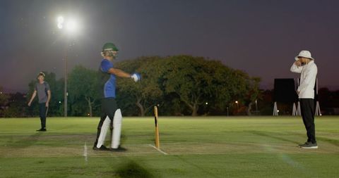 Night cricket match under floodlights indian batsman scoring runs in evening competition