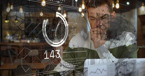 Man analyzing augmented reality data dashboard while working on laptop in cafe coworking
