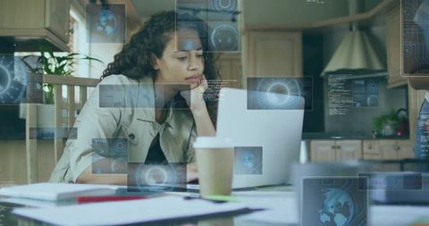 Woman Analyzing Data on Laptop in Contemporary Home Kitchen